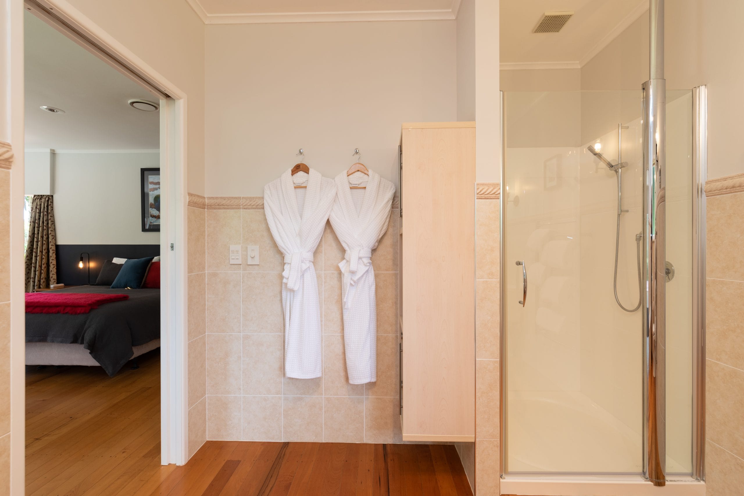 Bathrobes and and separate shower in the Takahē suite's full size ensuite bathroom.