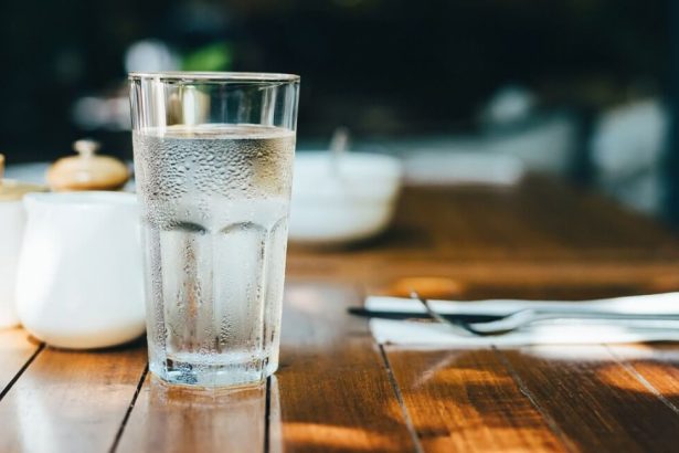 Cool glass of fresh drinking water with condensation of the outside.