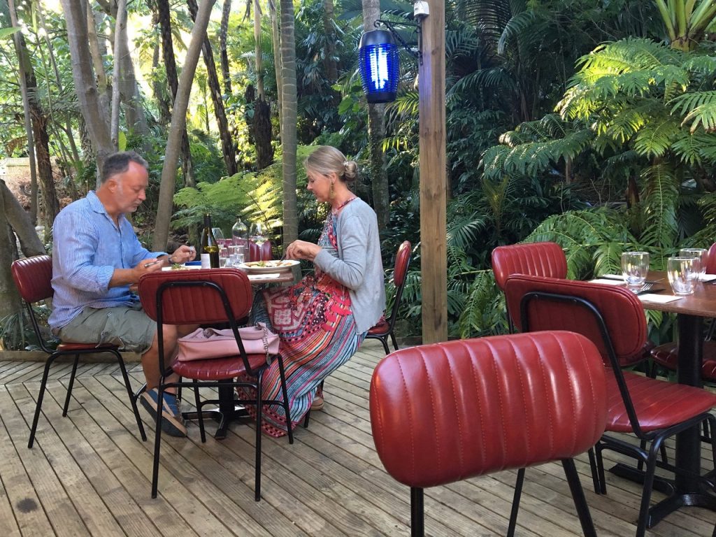 A couple enjoying lunch in the sub-tropical gardens of Maha Restaurant, Kerikeri.