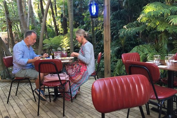 A couple enjoying lunch in the sub-tropical gardens of Maha Restaurant, Kerikeri.